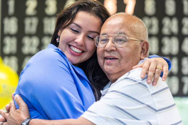 istock Hispanic young woman embracing a senior man 1223484003