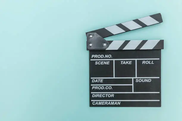 Filmmaker profession. Classic director empty film making clapperboard or movie slate isolated on blue background. Video production film cinema industry concept. Flat lay top view copy space mock up