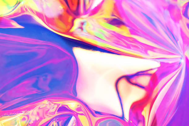 Holographic iridescent surface. Copy space. Bright colorful hologram background. Wrinkled abstract texture with multiple colors. Neon surface