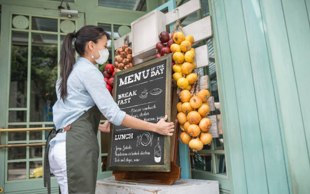 istock Business owner reopening a restaurant while wearing a facemask 1223488534