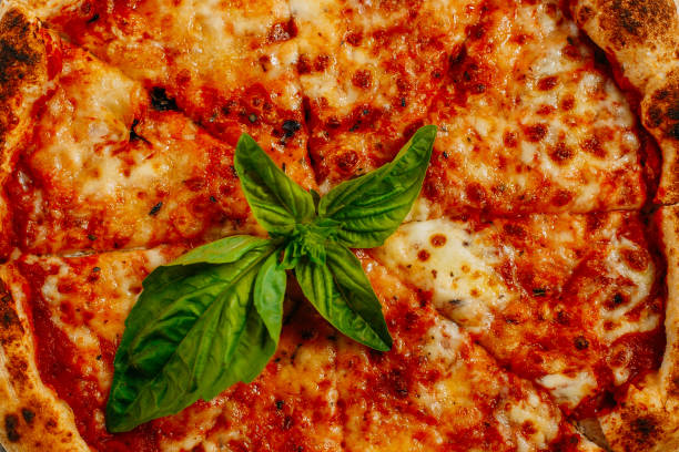 istock Italian pizza with mozzarella cheese and basil on a marble table 1223488557