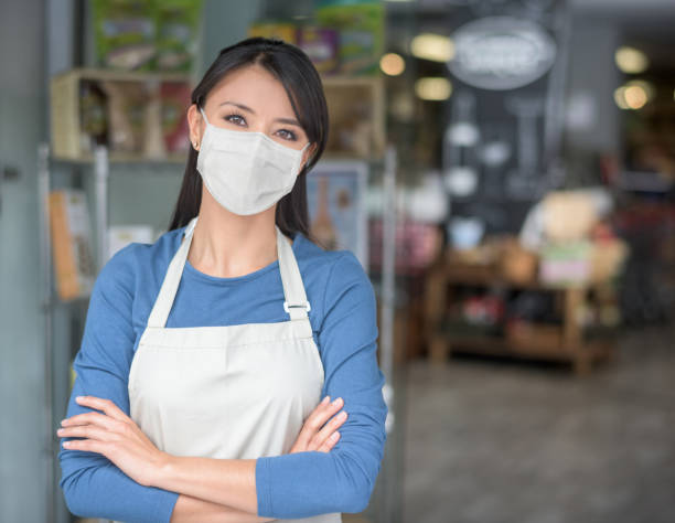 istock Business owner working at a grocery store wearing a facemask 1223488570
