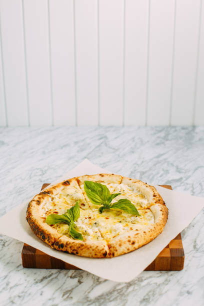 istock Italian pizza with mozzarella cheese and basil on a marble table 1223488938