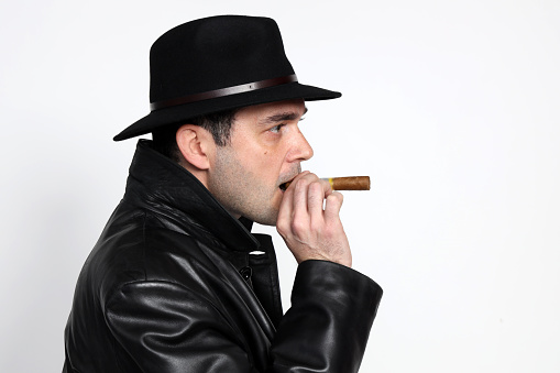 Pensive businessman in a limousine smoking cigar looking through window