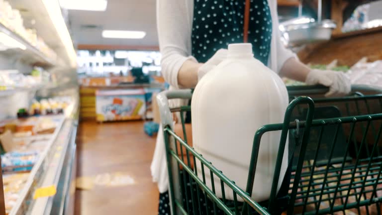 An unrecognizable woman shops for groceries during COVID-19 pandemic