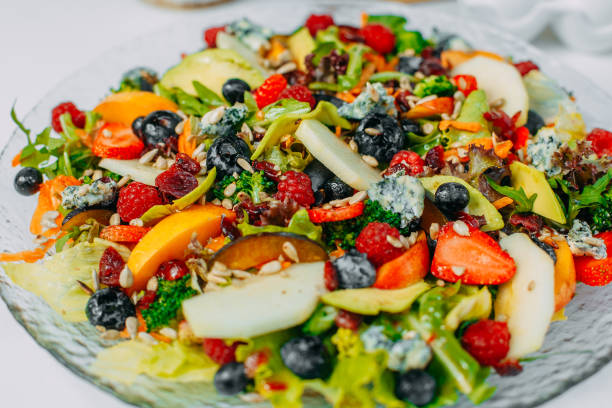 istock Fruit salad on a plate, healthy food isolated on white background 1223492599