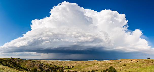 Panoramic landscape and view of a cumulonimbus storm cloud from a supercell thunderstorm in the Nebraska sandhills.
