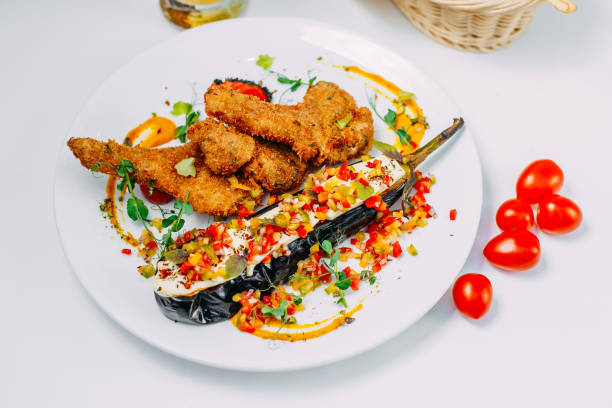 istock breaded chicken with stuffed eggplant and pepper on an isolated white background 1223496075