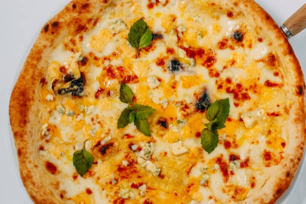 istock Italian pizza with different types of cheese and basil on a white background 1223496583