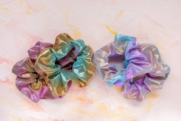 istock Four trendy holographic scrunchies on pink background 1223497351