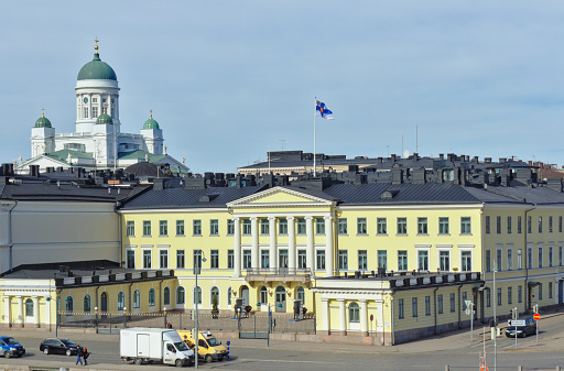 Helsinki, Finland – Mars 29, 2019: The Presidential Palace belongs to one of official residences of the president of Finland. On the left site the Helsinki Cathedral.