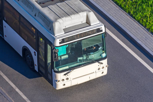 istock View from above on a white passenger city bus, a cabin and a drivers windshield on a highway. 1223498272