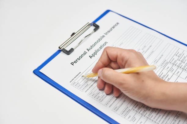 istock Filling insurance form. Applying for auto insurance 1223498494