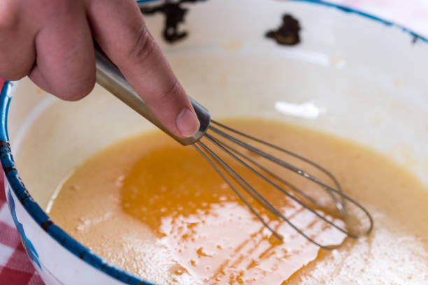 istock Hand mixing raw eggs in the metal bowl 1223498543