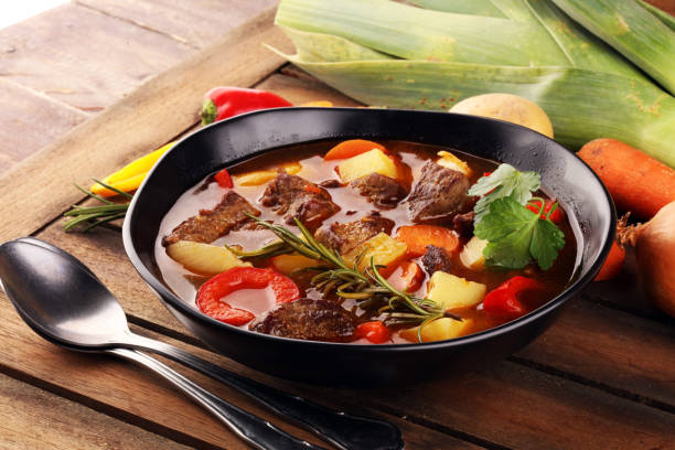 istock Meat stew with vegetables. Beef stew with potatoes, carrots and fresh herbs on table. 1223499573