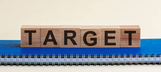 istock The word TARGET is written in wooden cubes located on a blue diary, white background. 1223499721