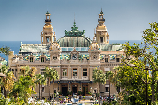 Monaco, Monte-Carlo, 02 October 2019: Casino Monte Carlo, main sight of the principality casino surrounded of the green trees, the updated facade, through the fountain