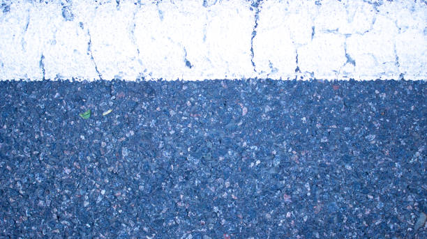 istock Old and cracked white horizontal strip of road surface from above. 1223500737