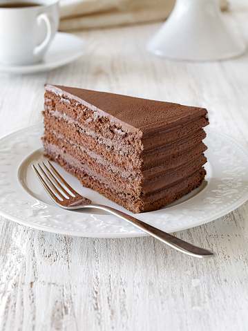 Chocolate cake slice on a wooden background