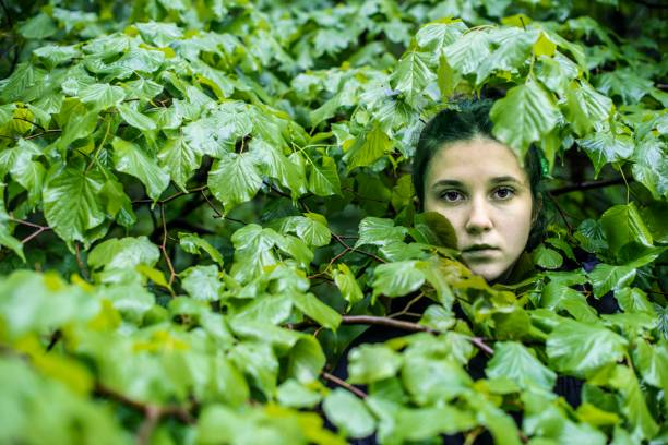 istock A young girl hiding in the forest 1223503809