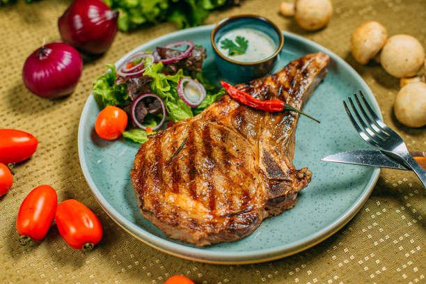 istock steak with vegetables and sauce on a plate, on a decorated table 1223504861
