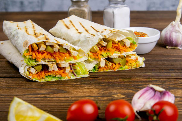 istock Homemade shawarma, burrito, chicken roll with vegetables and sauce. Front view ingredients 1223505492
