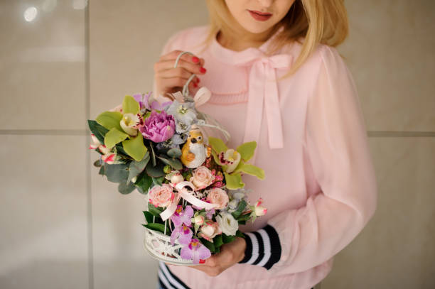 istock bright decorative composition of orchids in womans hands 1223505684