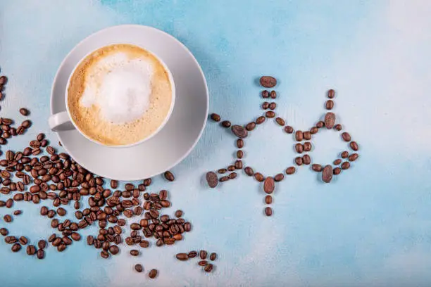 Photo of a cup of coffee with caffeine molecule created by coffee beans.
