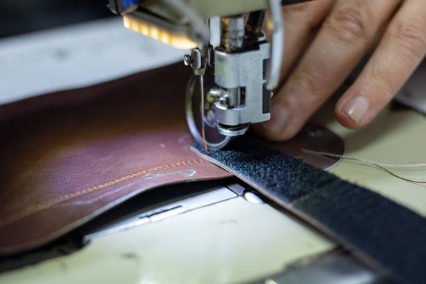 istock Man sewing a leather for making shoes 1223506698
