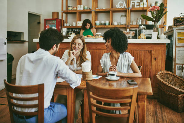 istock Multi-Ethnic Cafe Customers Enjoying Coffee and Conversation 1223507466