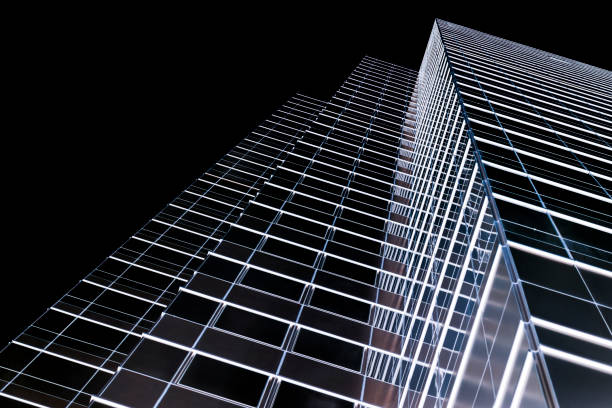 Low angle view of modern office building at night, skyscrapers, black background with copy space