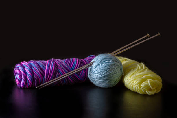 Colorful yarn with kitting needle on a black background