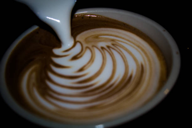 istock Latte art with steam milk on a black background 1223516566