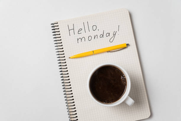 istock Notepad with the words Hello monday on white background. Pen and morning coffee on notebook. 1223517447