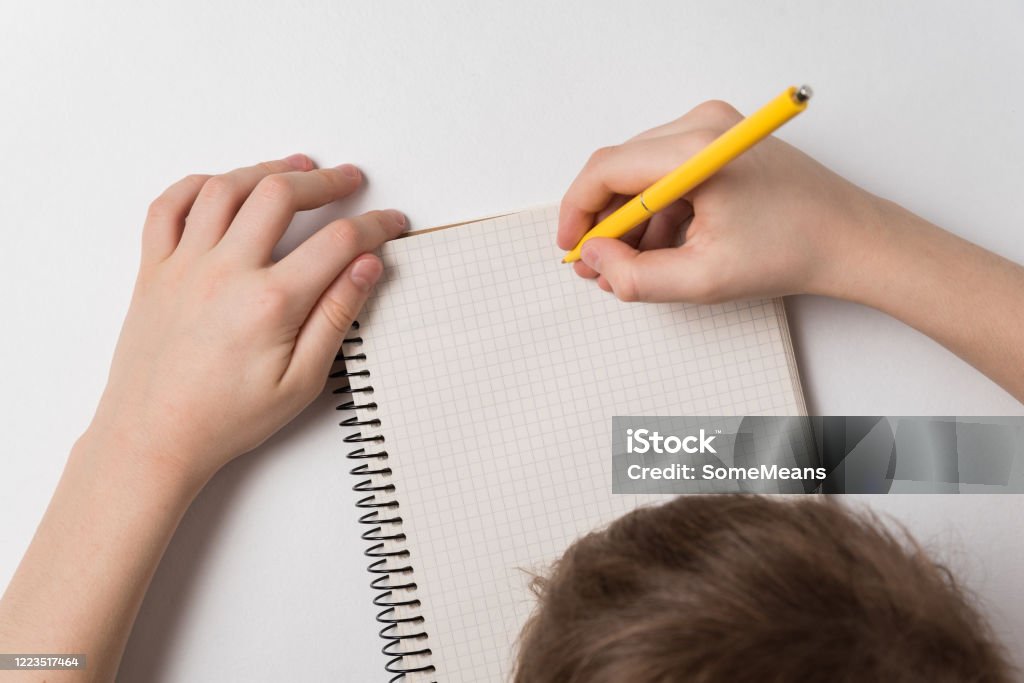 Homework On Notebook Picture Child Writes In Notebook Doing Homework White Background Top View Stock ...