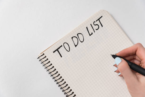 istock Female hand writing To-do list. Notebook on white background. Plan for day month 1223517484