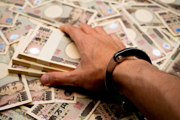 istock Financial crime-handcuffs and wads 1223518583