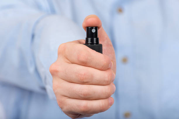 istock Man's hand holds protective antibacterial spray. Front view. Close up 1223519979
