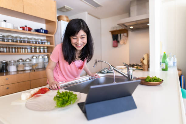 istock Woman looking at recipe in digital tablet 1223520020