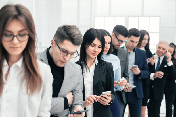 istock group of young people reading messages on their smartphones 1223521849