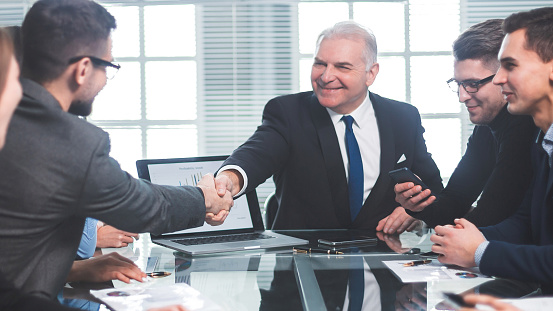 business partners shaking hands during a working meeting. concept of partnership