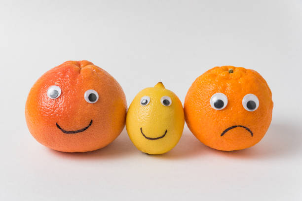 istock Grapefruit, lemon and orange with funny faces on white background. optimist and pessimist concept 1223522512