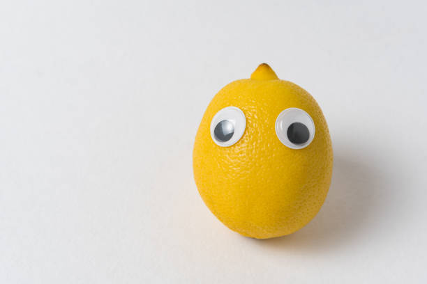 istock Fresh Lemon with eyes on white background. Food with Funny Face. 1223522740