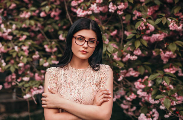istock Calm woman standing next to blooming tree 1223524684