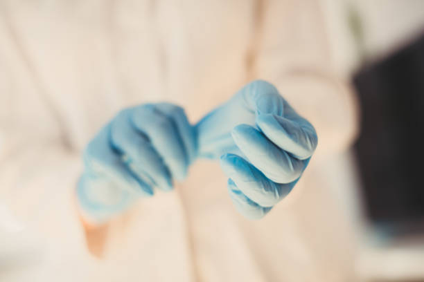 istock Medical nurse putting on blue sterilized surgical gloves 1223524767