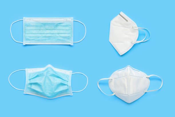 istock KN95 and surgical face mask on blue background protection against pm 2.5 polution and COVID-19 coronavirus. Healthcare and medical concept 1223524868