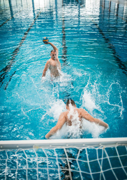 istock Father and Son Practicing Water polo at Swimming Pool 1223527976