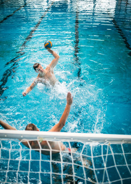 istock Father and Son Practicing Water polo at Swimming Pool 1223528041