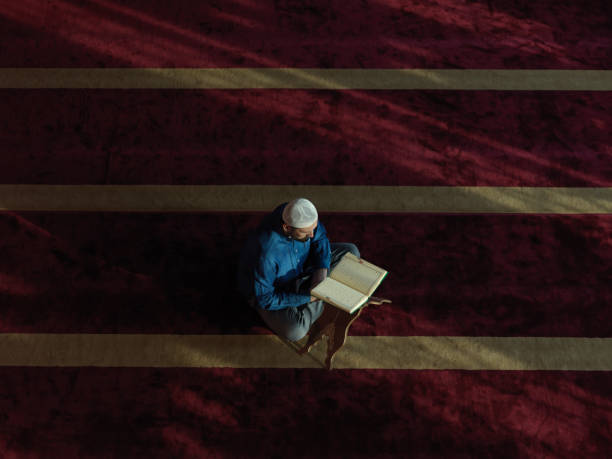 muslim man praying inside the mosque top view