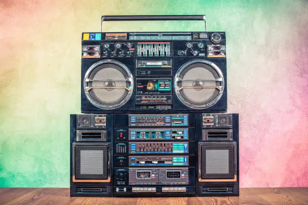Retro boombox ghetto blaster outdated portable radio receivers with cassette recorder from 80s front gradient colored wall background. Rap, Hip Hop, R&B music concept. Vintage old style filtered photo